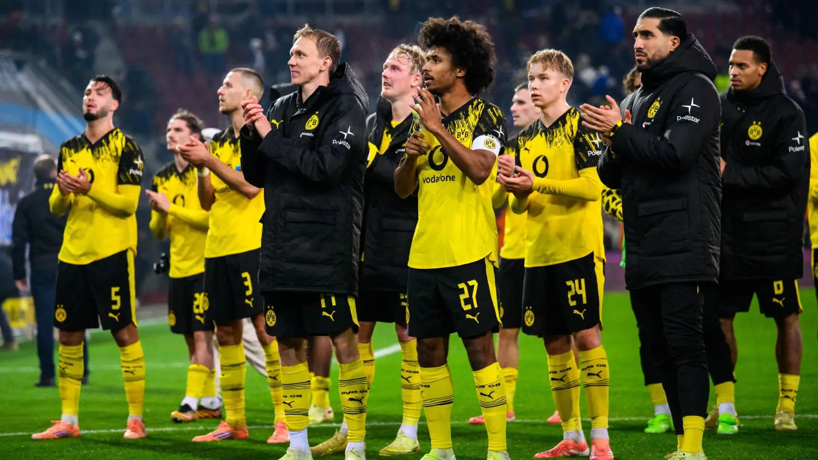 Hauptsache gewonnen: Dortmunds Spieler nach dem 1:0 in Augsburg vor ihren mitgereisten Fans.  (Foto: Tom Weller/dpa)