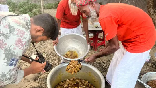 Ein Kameramann filmt im selbst ernannten YouTube-Dorf die Zubereitung von Hammelcurry, um es anschließend mehr als 100 Waisenkindern einer religiösen Schule zu servieren.K (Foto: Nazrul Islam/dpa)