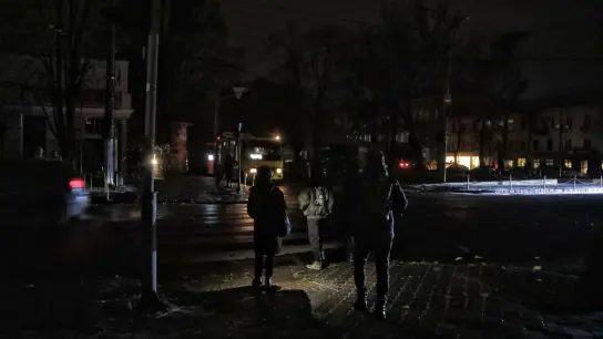 Fußgänger halten sich in Odessa an einer Kreuzung auf einer dunklen Straße auf, da die Stadt von Stromausfällen betroffen ist. (Foto: -/Ukrinform/dpa)