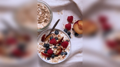 Ein gesundes Frühstücksmüsli lässt sich einfach aus Naturjoghurt, Haferflocken, Sonnenblumenkernen und Mandeln herstellen. Dazu: eine Hand voll Obst der Saison. (Foto: Anna Hirte/dpa-tmn)
