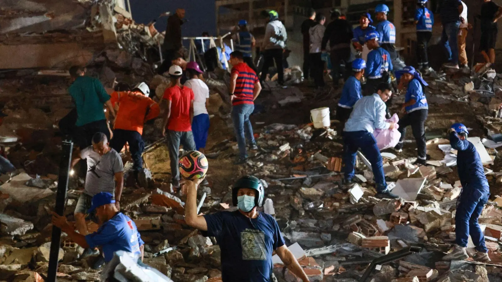 Viele Retter arbeiten mit bloßen Händen. (Foto: Javier Campos/AP/dpa)